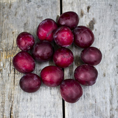 Sweet plums on wooden background