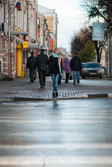 Woman about to cross the road at a pedestrian crossing