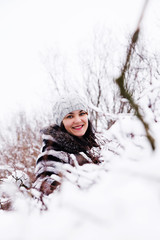 Fototapeta na wymiar portrait of woman in a snow bushes