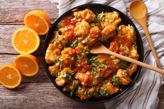 orange chicken in sweet and sour sauce close-up. horizontal top view 
