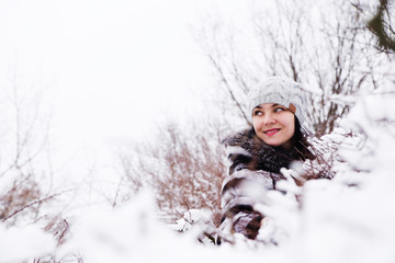Fototapeta na wymiar portrait of woman in a snow bushes