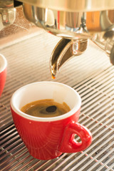 Fresh brew hot coffee from espresso machine with vintage filter