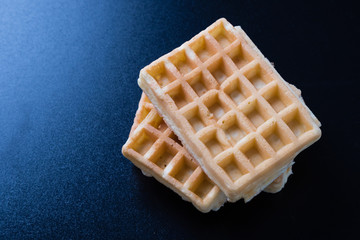 three waffles on black table