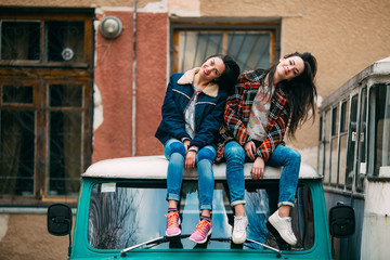 two funny street girls on the retro bus