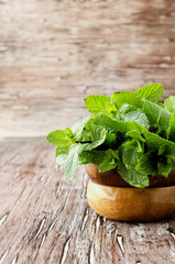 Fresh mint in a wooden bowl, selective focus