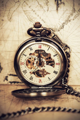 Vintage pocket watch on old map