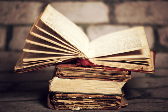 Old books on grunge wall background