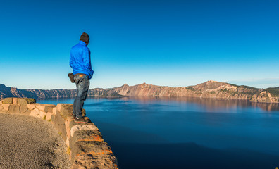 scenic view of a man stand over look to Crater lake National park ,Oregon state,usa.
