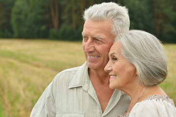 Senior couple at  summer field