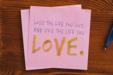 Sticky note with text love the life you live