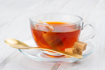 cup of tea with bag on white wood