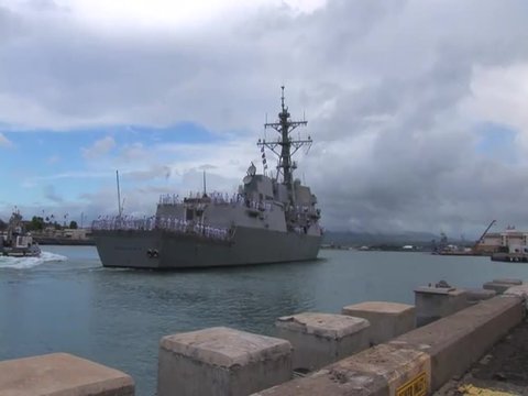 The guided missile destroyer USS Chung Hoon departs Pearl Harbor Hawaii on a mission.