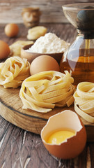 Uncooked pasta with flour on the table, selective focus