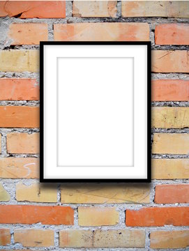 Close-up of one black picture frame on orange brick wall background
