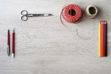 Desktop mockup, top view, with colorful stationery and central copy space, on wooden background