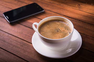 Coffee cup and phone