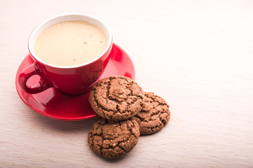 Cup with coffee and chocolate cookie