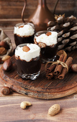 hot chocolate in glass cups and cream with nuts