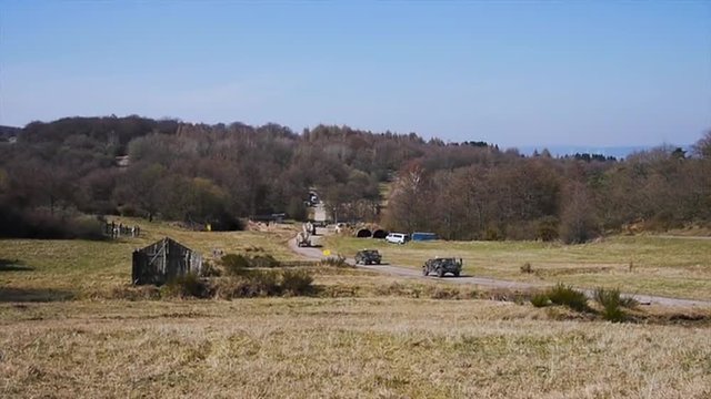 A simulated IED bomb is set off along a country road in this simulated battle scenario.