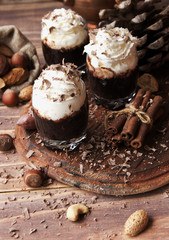 hot chocolate in glass cups and cream with nuts