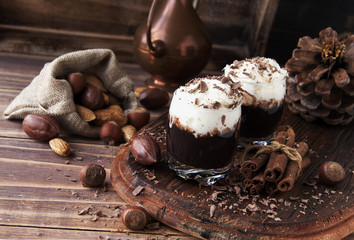 hot chocolate in glass cups and cream with nuts