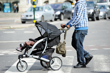 Child stroller and man on zebra crossing