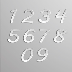 Naklejka premium Paper numbers set on gray background
