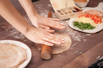 Fototapeta premium hands chef rolling pastry for tacos