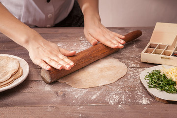 hands chef rolling pastry for tacos