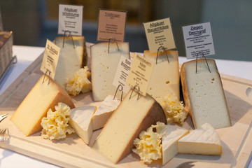 cheeseboard with choice of different sorts of cheese and labeling