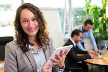 Fototapeta premium Young attractive businesswoman working at the office with associ
