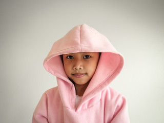 Close up adorable asian children wear pink jacket with a hood.