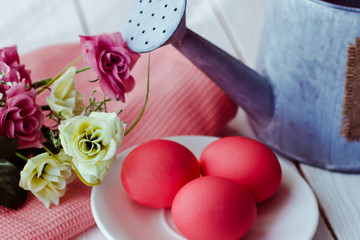 Easter pink Easter background with eggs and flowers on white wooden background