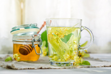 Sweet linden tea with honey in sunny day