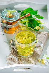 Sweet linden tea with honey in summer day