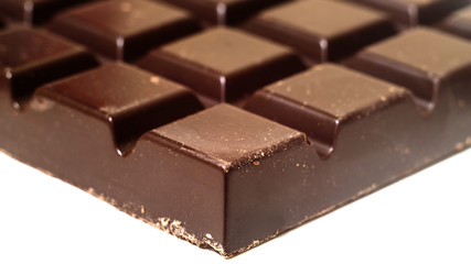 Black chocolate bar isolated on white, close-up view