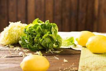fresh lettuce and lemon on a wooden background