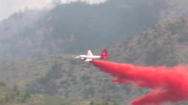 Fixed wing aircraft make fire retardant drops on the High Park fire burns in Colorado.