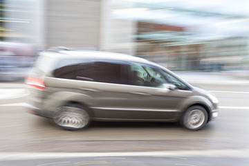 Fototapeta na wymiar Car in motion blur, car driving fast in city