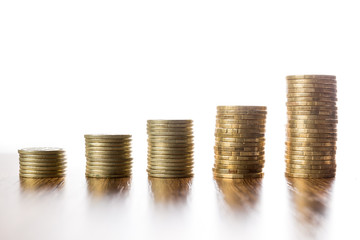 Towers of coins on wooden table