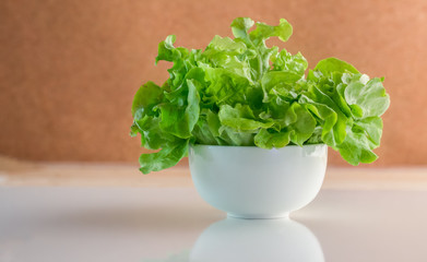 fresh salad bowl with brown background