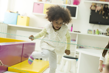 Fototapeta na wymiar Little african girl at the playroom