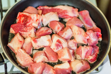Raw pork on frying pan