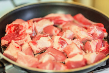 Raw pork on frying pan
