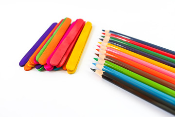 colorful pencil crayons over a white background