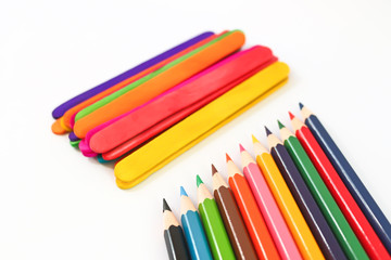 colorful pencil crayons over a white background