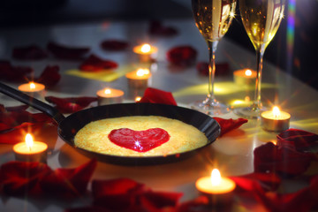 Romantic dinner pancake in the pan with rose petals