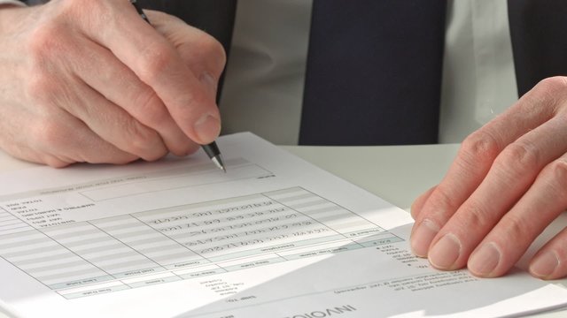 Businessman in suit signing a document