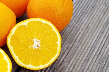 fresh organic oranges on wooden background