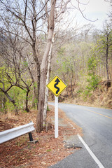 Road curve with warning sign